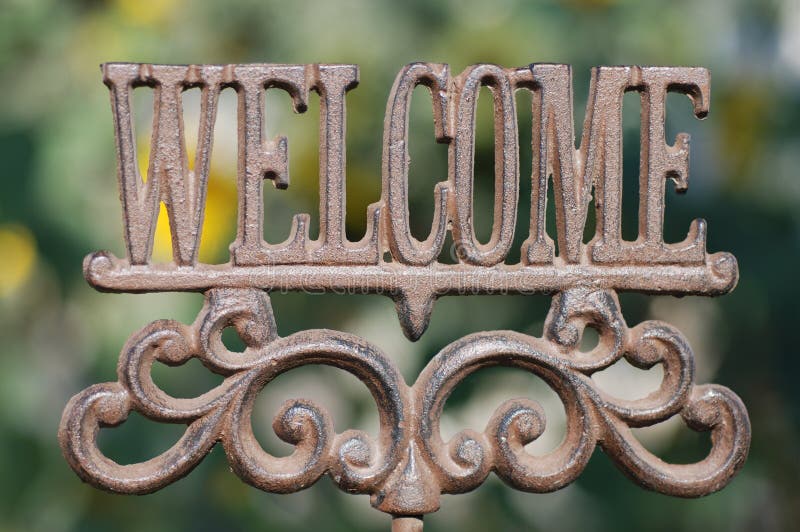 Horizontal image of an iron sign spelling out the word Welcom. Horizontal image of an iron sign spelling out the word Welcom.