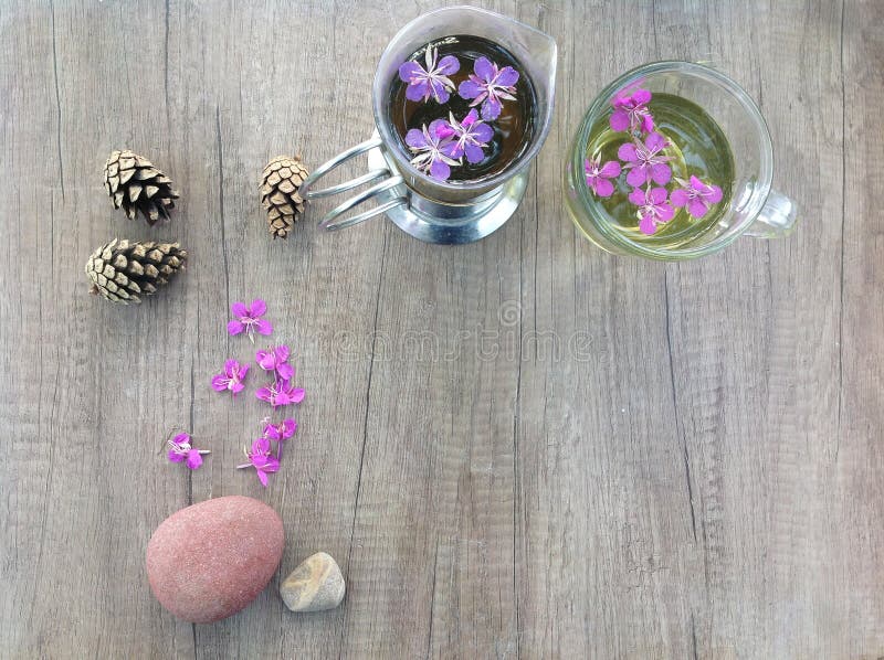 Willow herb Ivan tea in cup and topcup at the wood table workplace stock photo Willow herb Ivan tea in cup and topcup at the wood table workplace stock photo
