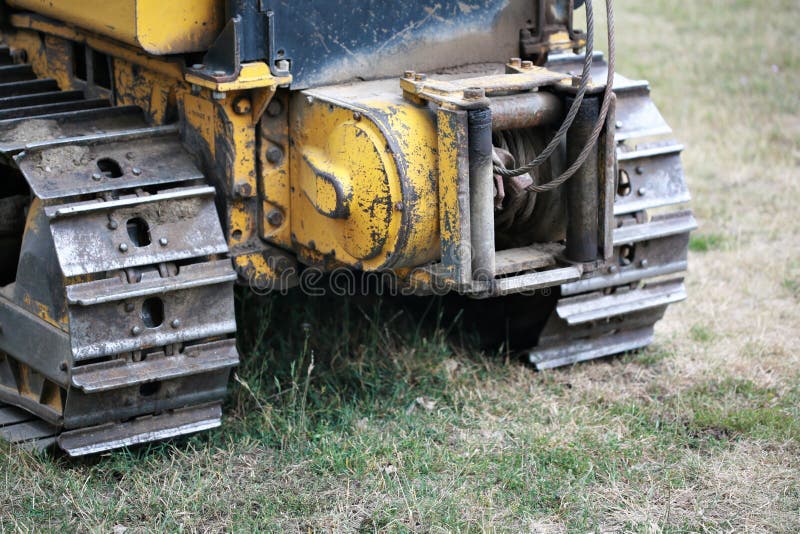 Rear view of a winch and tracks of a bull dozer excavating machine. Rear view of a winch and tracks of a bull dozer excavating machine.
