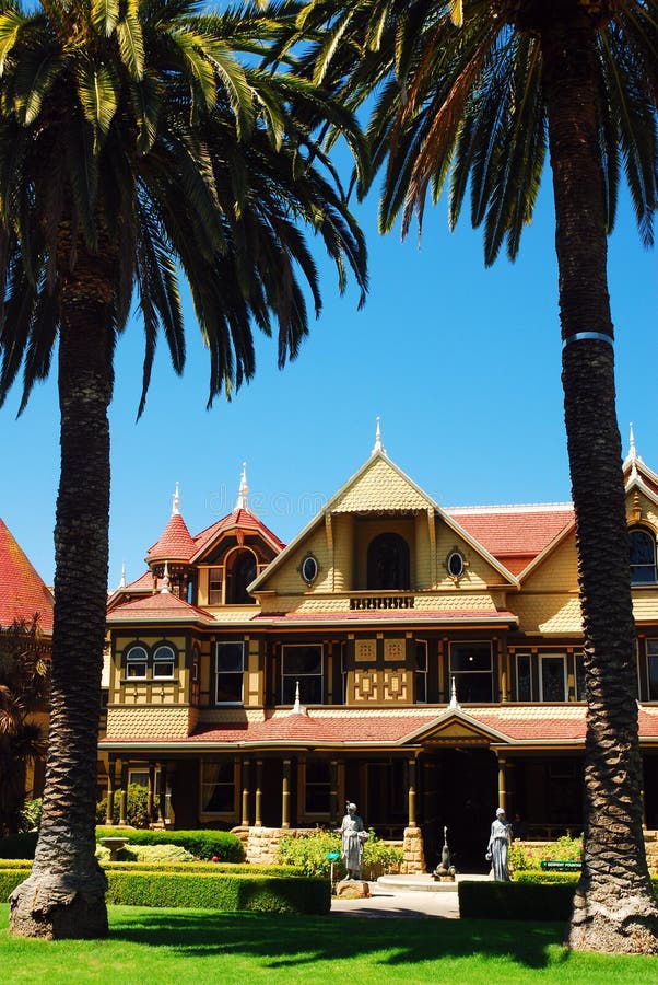 Winchester Mystery House, San Jose, California. Two palm trees frame the historic Winchester Mystery House, a haunted home in San Jose California