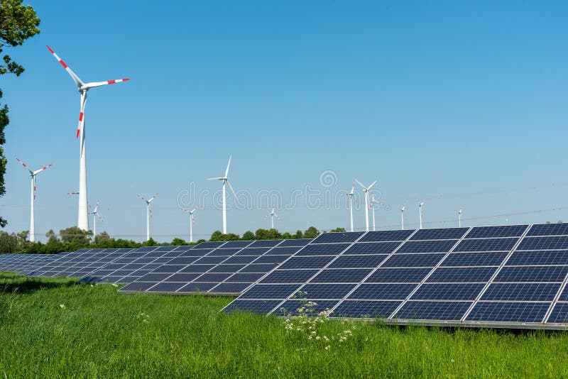 Wind engines and solar panels on a sunny day stock photo