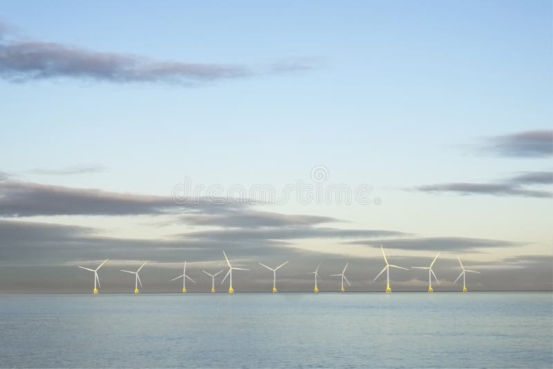 Wind farm in north sea ocean floating turbines on horizon offshore at Aberdeen to generate energy and electricity royalty free stock photos Wind farm in north sea ocean floating turbines on horizon offshore at Aberdeen to generate energy and electricity royalty free stock photos