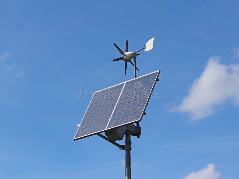 Wind generator and solar panel on a blue sky. Photovoltaic cells. Method of obtaining alternative energy. Ecologically clean electricity. High technology of electronics. Energy independence.