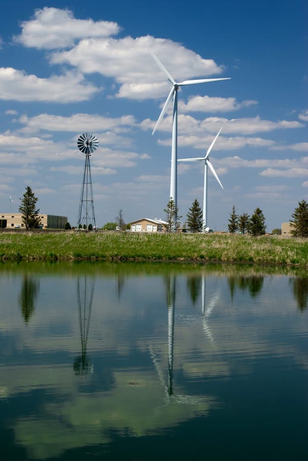 Reflection of Wind Mills in pond just outside Rochester, Minnesota. Both Modern and old style of Wind mills. Reflection of Wind Mills in pond just outside Rochester, Minnesota. Both Modern and old style of Wind mills.