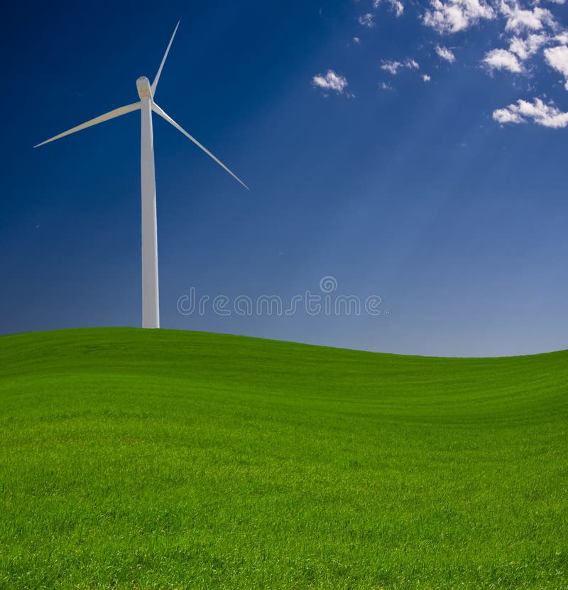 Wind Power turbine spins over green landscape