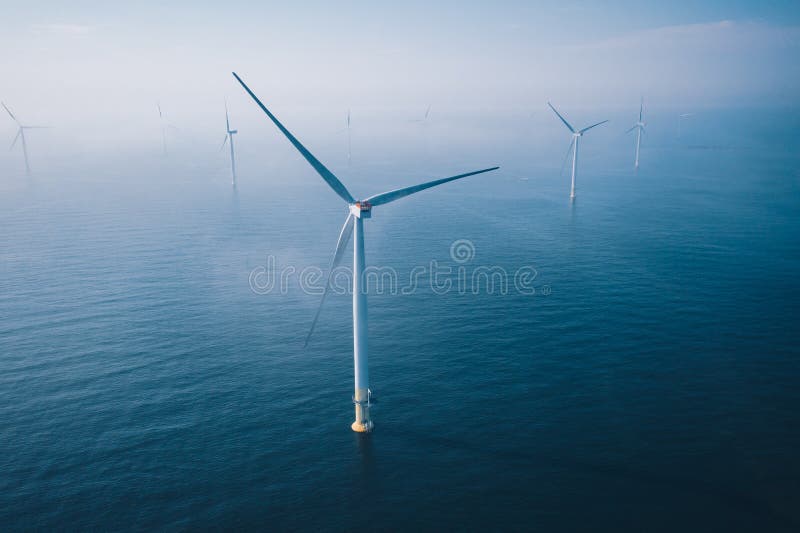 Wind turbine. Aerial view of wind turbines or windmills farm field in blue sea in Finland