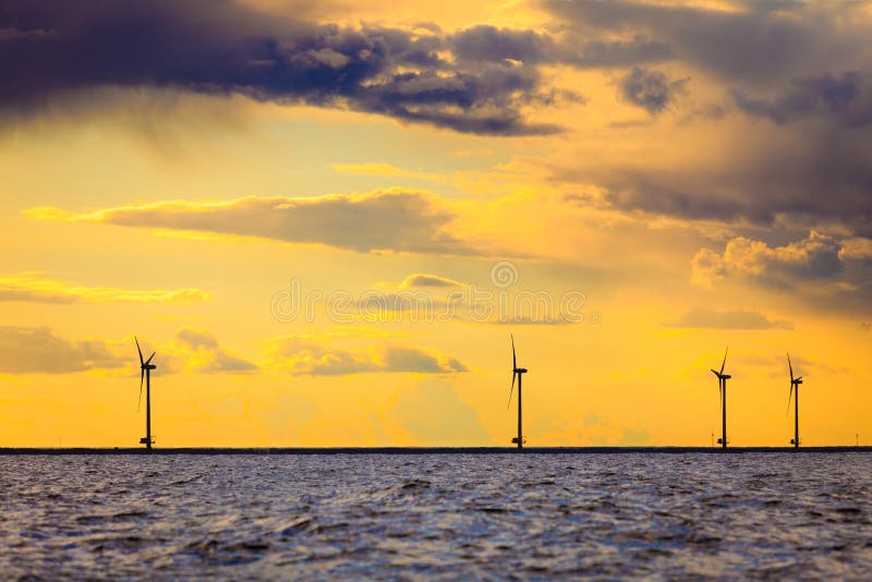 Wind turbines power generator farm along coast sea