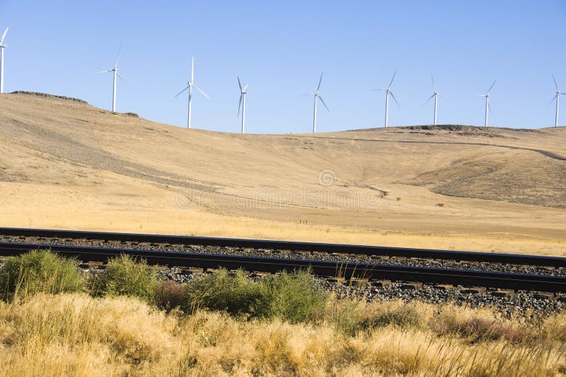 Wind turbines and railroad tracks.