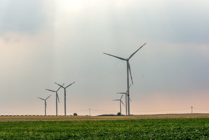 Wind farm on a field in the evening sun stock photo Wind farm on a field in the evening sun stock photo