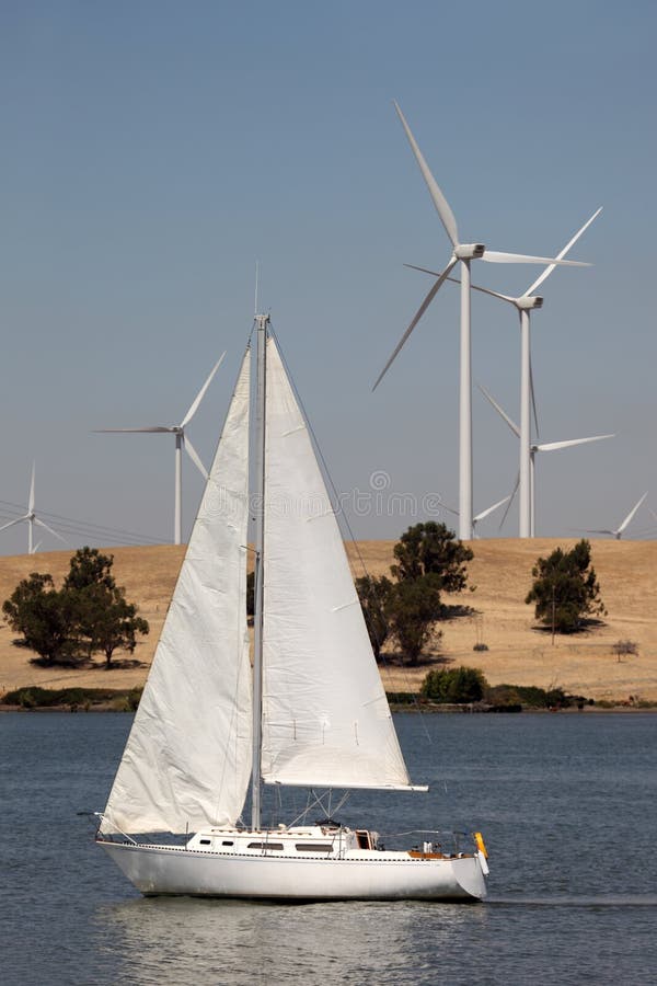 Wind Turbines and Sailboat stock image. Image of energy 11029709