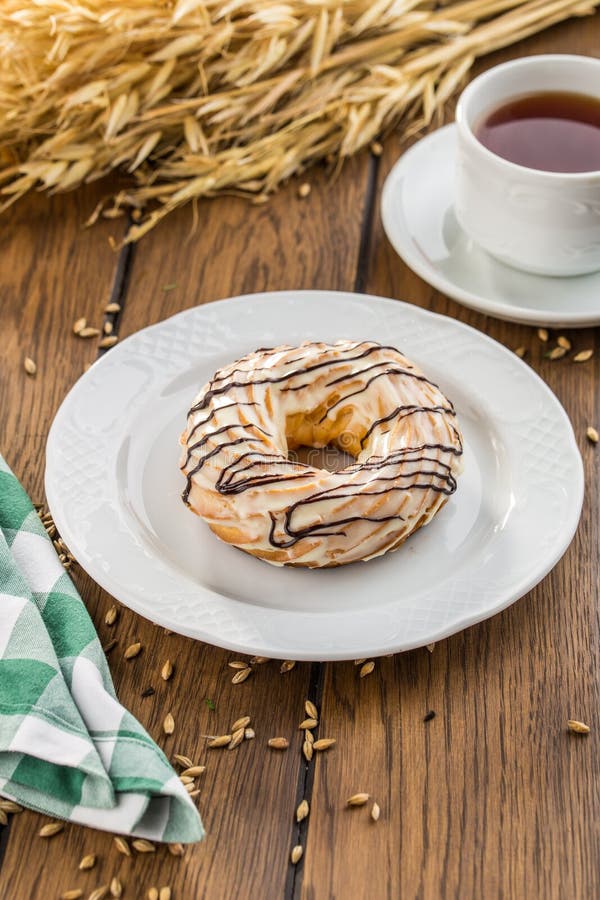 Windbeutelringe mit Schokoladenglasur Chouxgebäck auf Holztisch lizenzfreies stockbild Windbeutelringe mit Schokoladenglasur Chouxgebäck auf Holztisch lizenzfreies stockbild