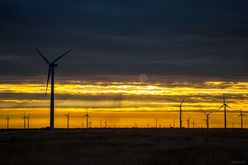 Wind Turbine Farm West Texas Sunrise Sunset so amazing as the clouds rolled in they left a pocket of Orange and red vibrant colors that shows the wind turbines silhouette . Wind Turbine Farm West Texas Sunrise Sunset so amazing as the clouds rolled in they left a pocket of Orange and red vibrant colors that shows the wind turbines silhouette .