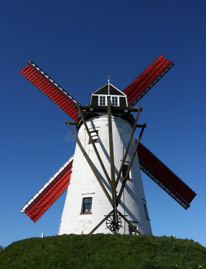 Picture of a windmill with a clear blue sky at the background. Picture taken near Bruges, Belgium.