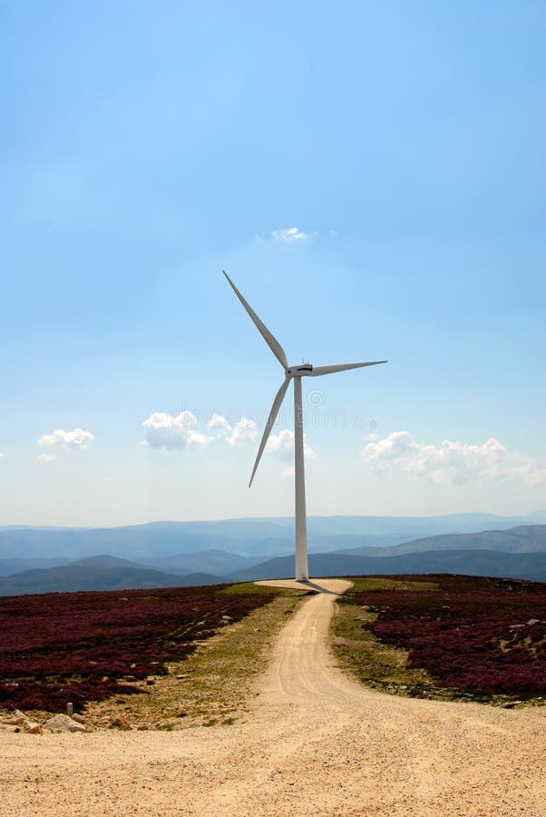 Photo of a road with wind turbine on the mountain. Photo of a road with wind turbine on the mountain