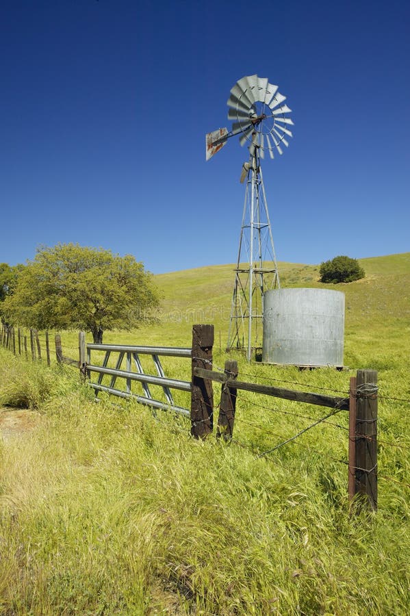 Windmill and green rolling hills off of Route 58 West of Bakersfield, CA