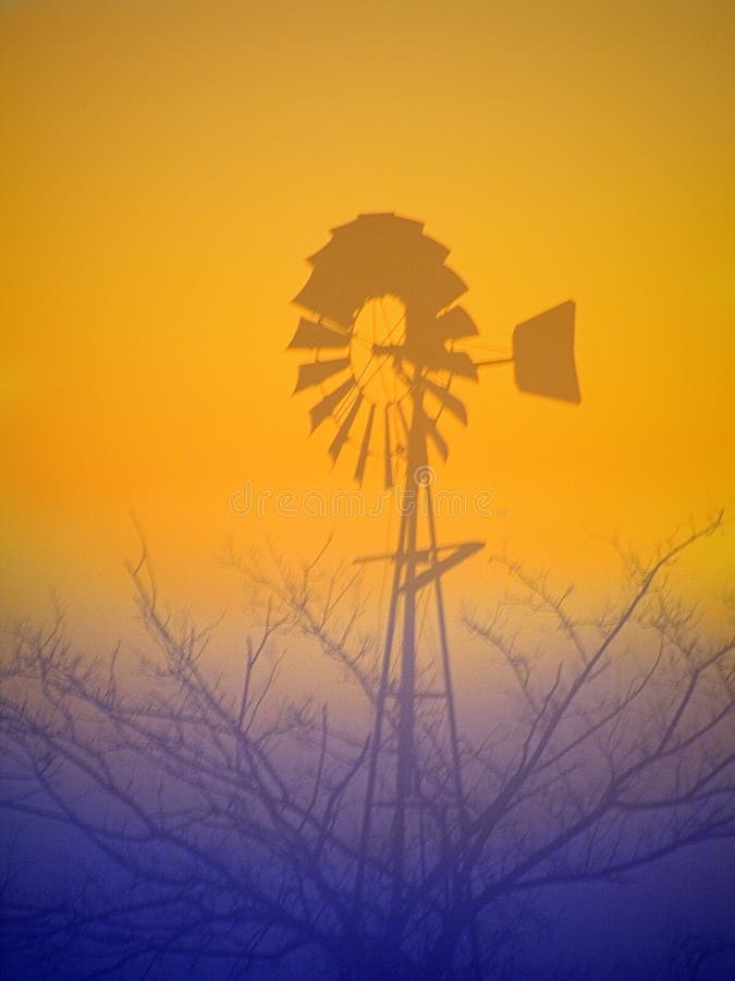 This a shot of a windmill silhouetted against sunrise in the fog. Australian outback illustrations