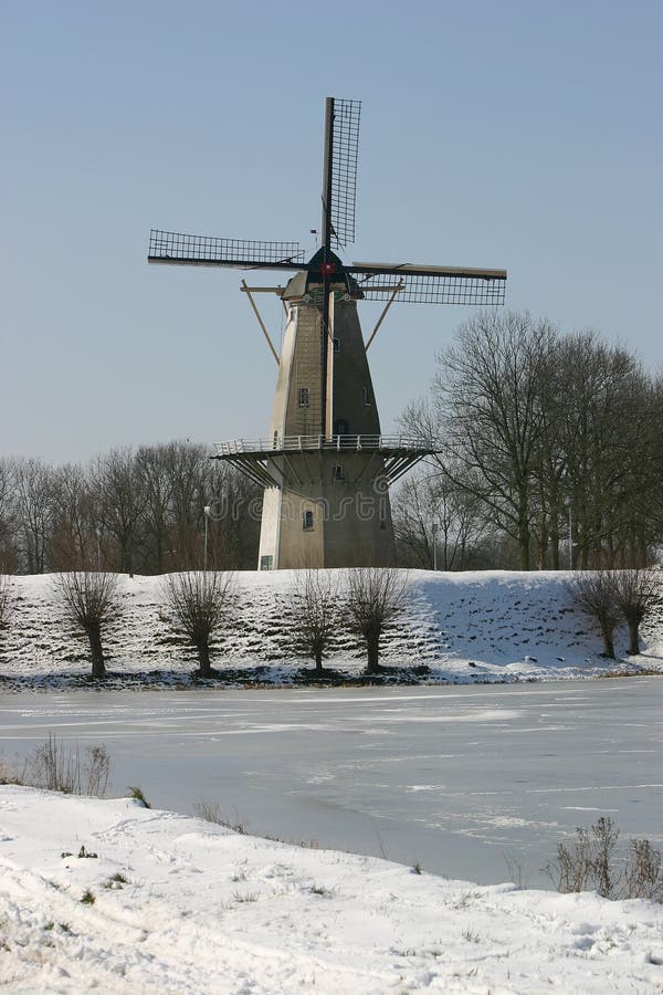 Windmill at frozen lake