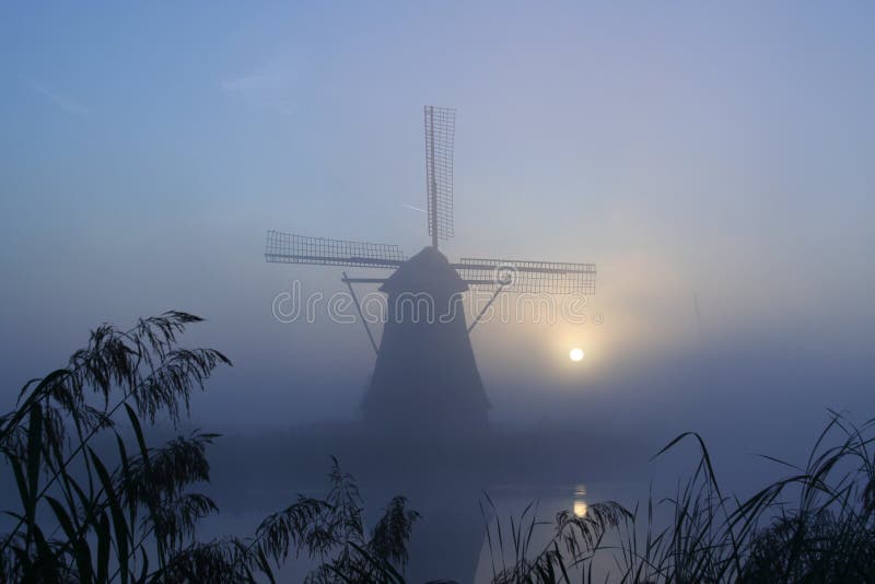 Windmill at a misty morning