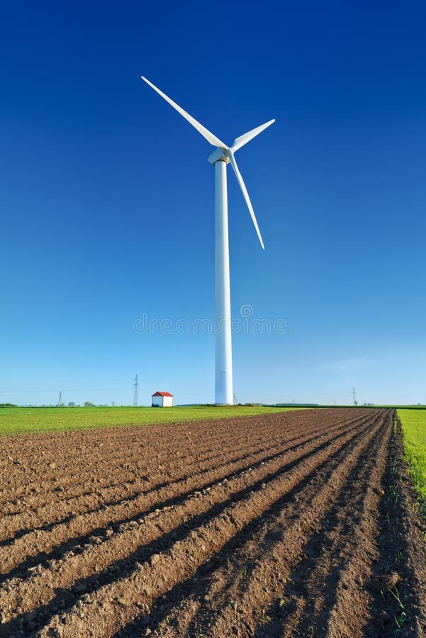 Windmill turbine on blue sky. Wind energy. Modern green power. royalty free stock photo