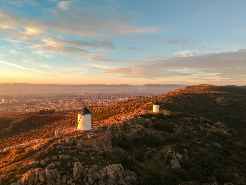 Windmills of Campo de Criptana on a hill covered in greenery during the sunset in Spain. The Windmills of Campo de Criptana on a hill covered in greenery during royalty free stock photography Windmills of Campo de Criptana on a hill covered in greenery during the sunset in Spain. The Windmills of Campo de Criptana on a hill covered in greenery during royalty free stock photography