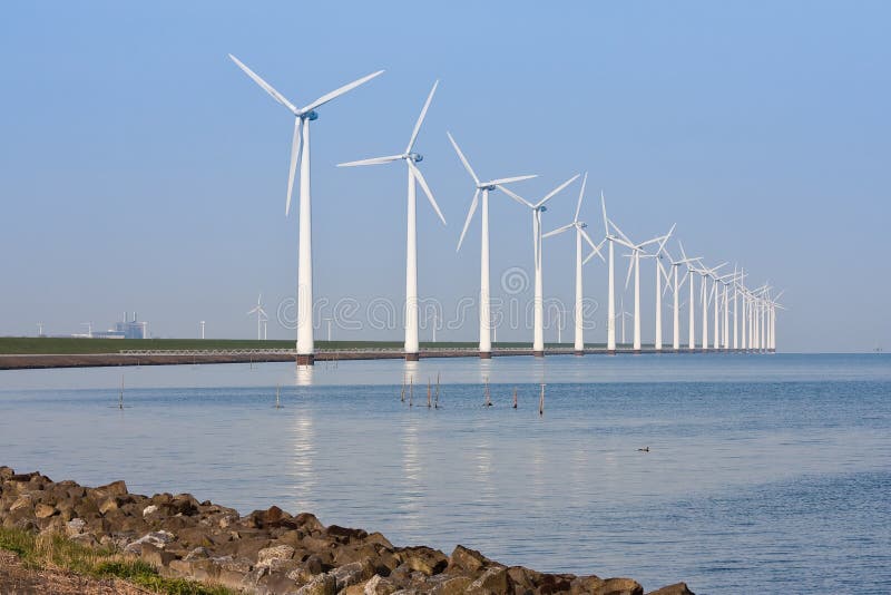 Windmills mirroring in the calm sea