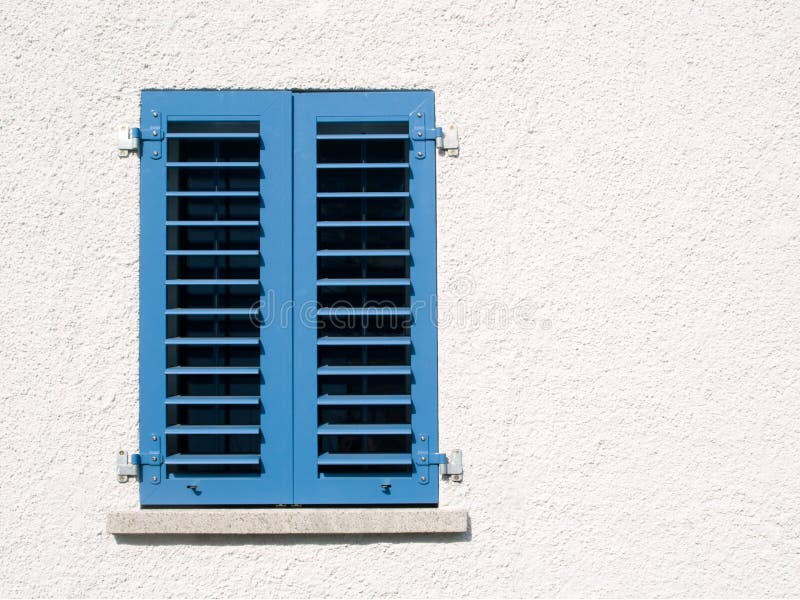 Window with blue shutters royalty free stock photo