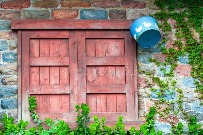 Window in a brick wall with wooden shutters