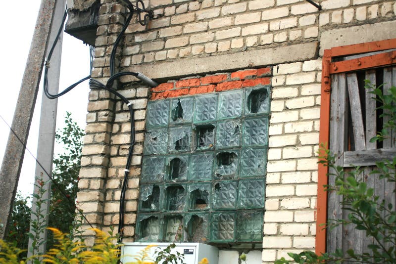 Window with Broken Glass Blocks. Glass Blocks in a Window on a Brick