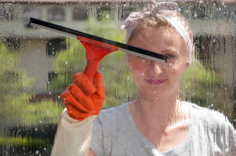 Window Cleaner Using a Squeegee To Wash a Window Stock Image Image of