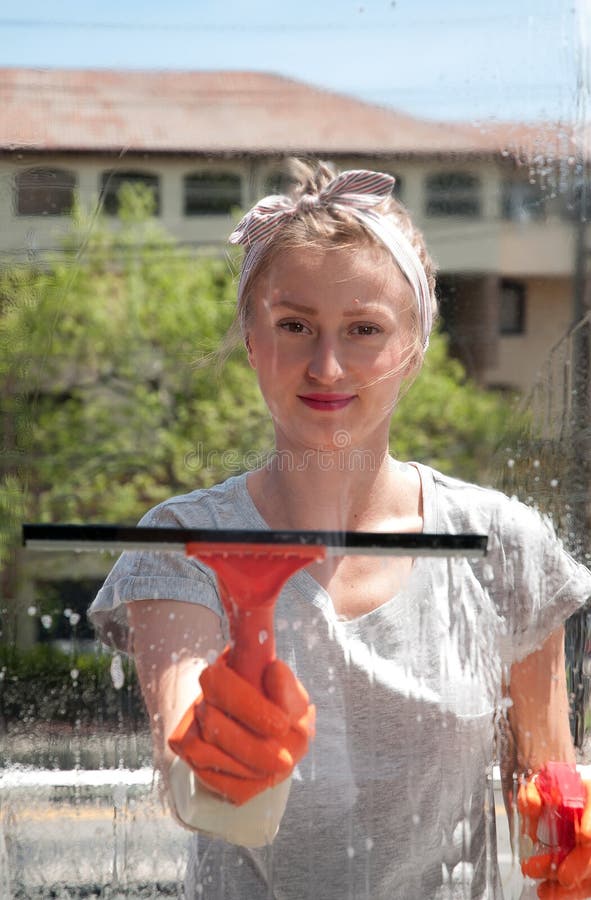 Window Cleaner Using a Squeegee To Wash a Window Stock Photo Image of