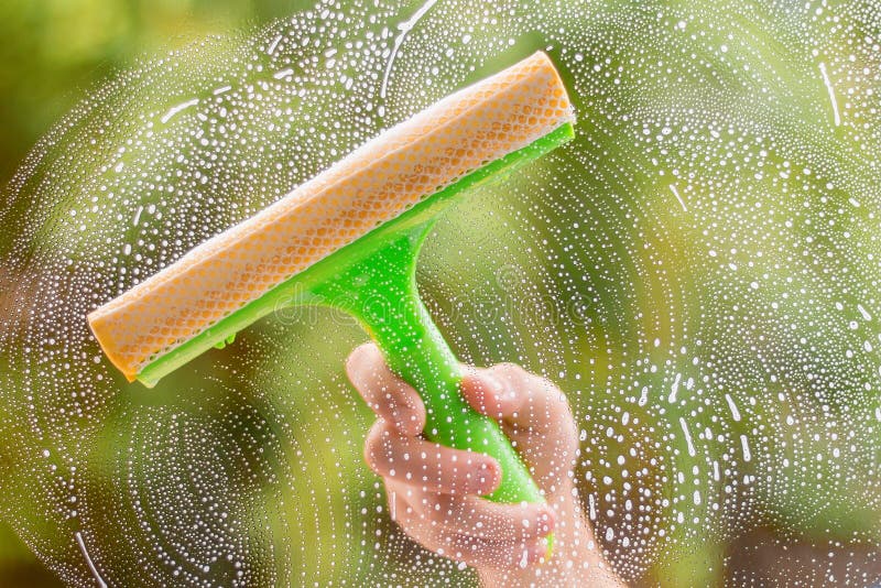 Window Cleaner Using a Squeegee To Wash a Window Stock Image Image of