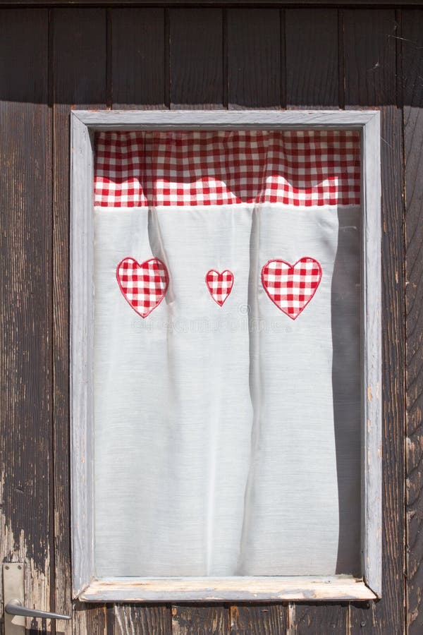 Window curtain with red heart shapes