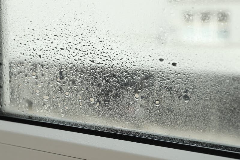 Window Glass with Drops of Condensate Indoors, Closeup Stock Photo