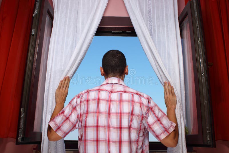 Man looking into distance through an open window. Man looking into distance through an open window