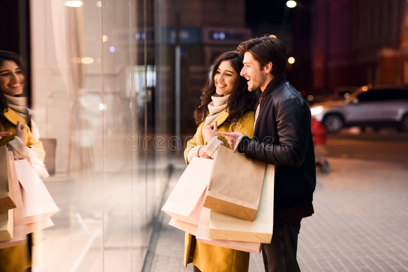 Window shopping. Young couple looking at showcase