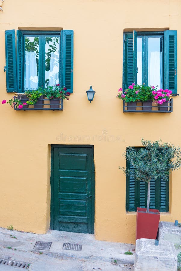 Windows with blue shutters on the white wall