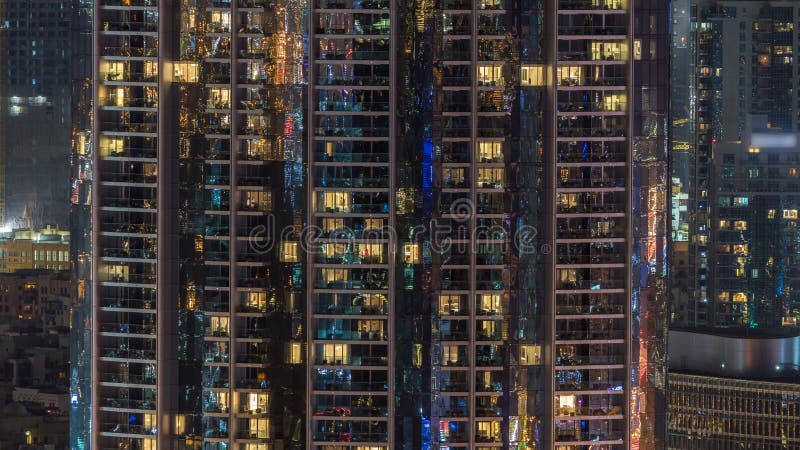 Windows del edificio de varios pisos de la gente interior y móvil de la iluminación de cristal y de acero dentro del timelapse