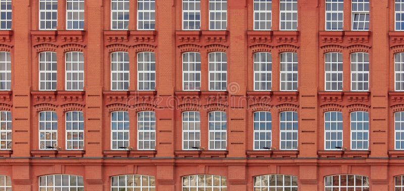 Windows in a multi-storey brick building as a background