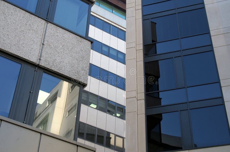 Reflections in the windows of a group of large modern office buildings in a city business district royalty free stock images Reflections in the windows of a group of large modern office buildings in a city business district royalty free stock images