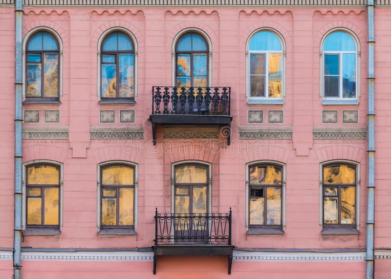 Windows in row and balconies on facade of historic building royalty free stock photo