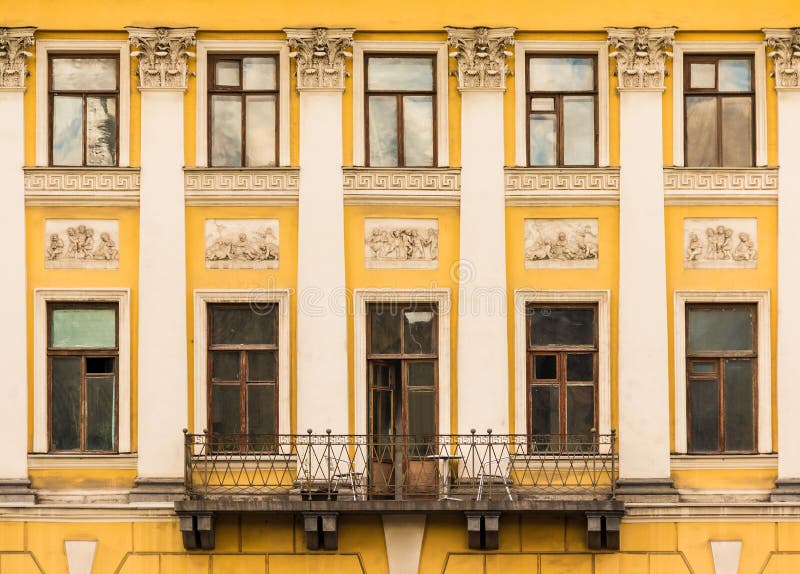 Windows in row and balcony on facade of historic building stock photos