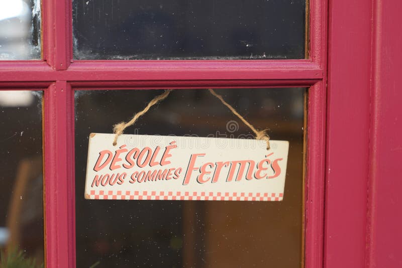 Windows sign shop panel write in french desole nous sommes ferme means sorry we are closed on store entrance