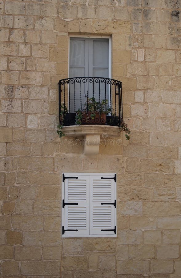 Windows on a wall in Malta stock photo. Image of railing 58449384