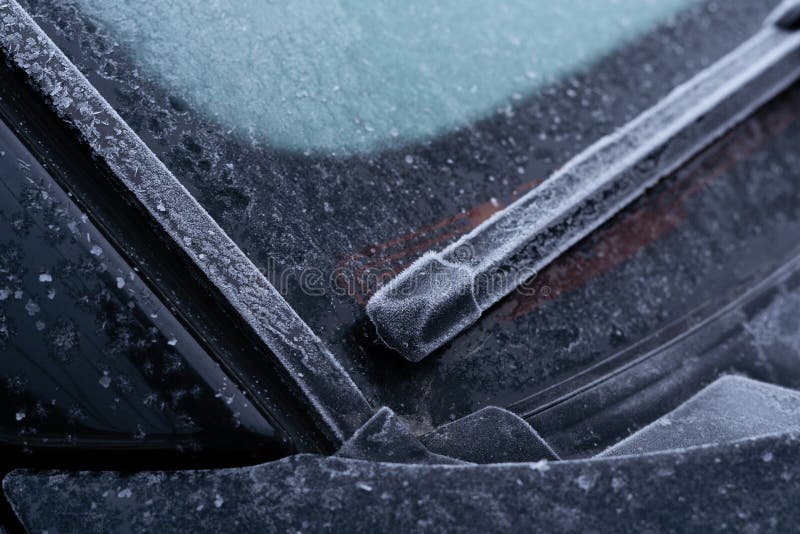 Windshield Wipers in a Car Covered with Frost in the Morning of Winter