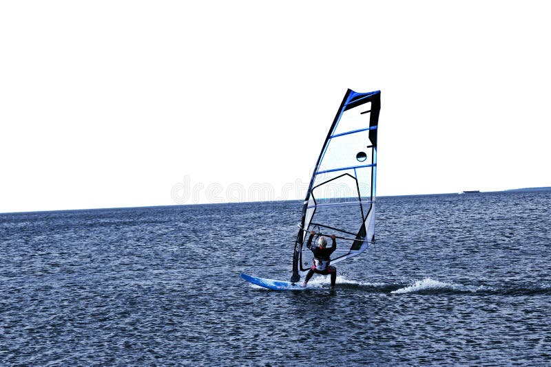 Windsurfer быстро скользит над голубым морем E стоковая фотография rf Windsurfer быстро скользит над голубым морем E стоковая фотография rf
