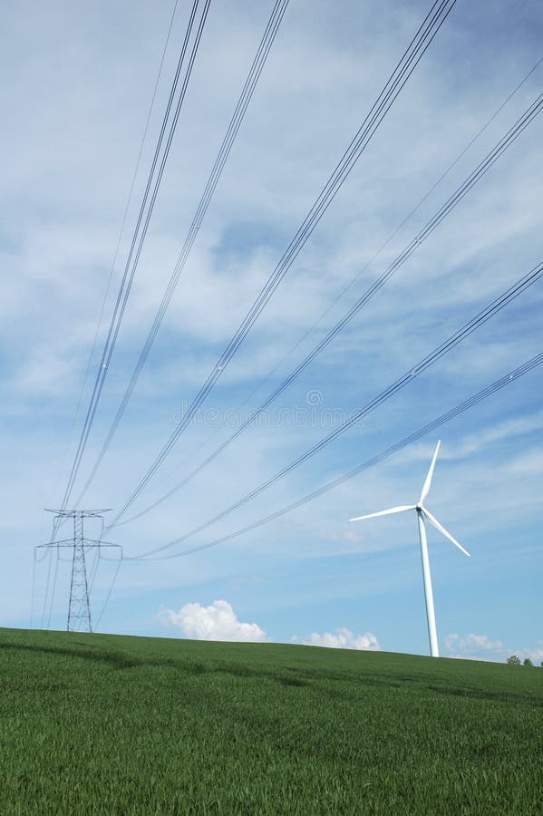 A windturbine close to a electric pylon