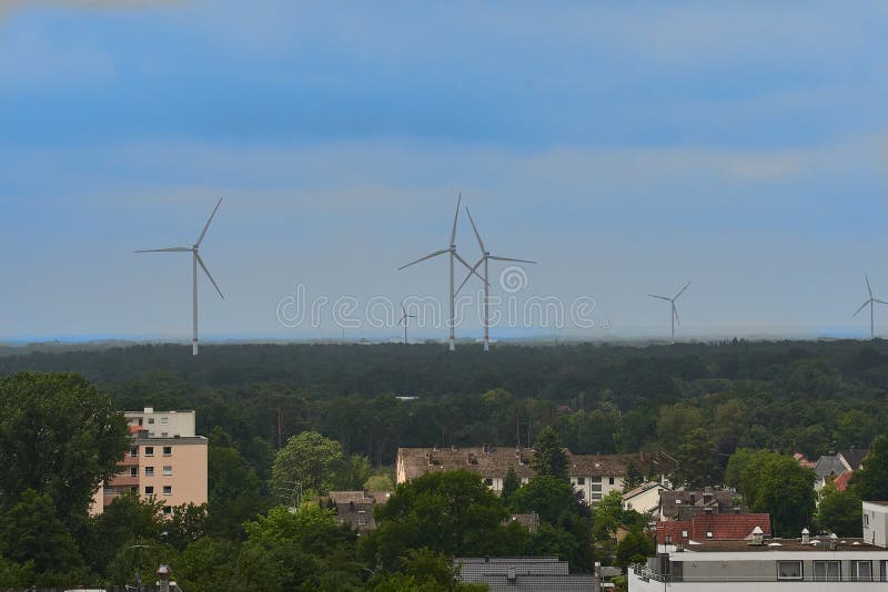 Windturbines on the horizon of a town