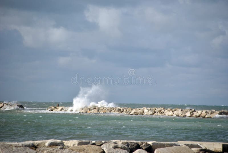 Windy day at sea with big waves against rocks stock photo Windy day at sea with big waves against rocks stock photo
