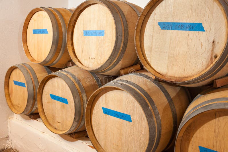 Wine Barrels and Bottles Age Inside Dark Cellar. Stock Image Image of