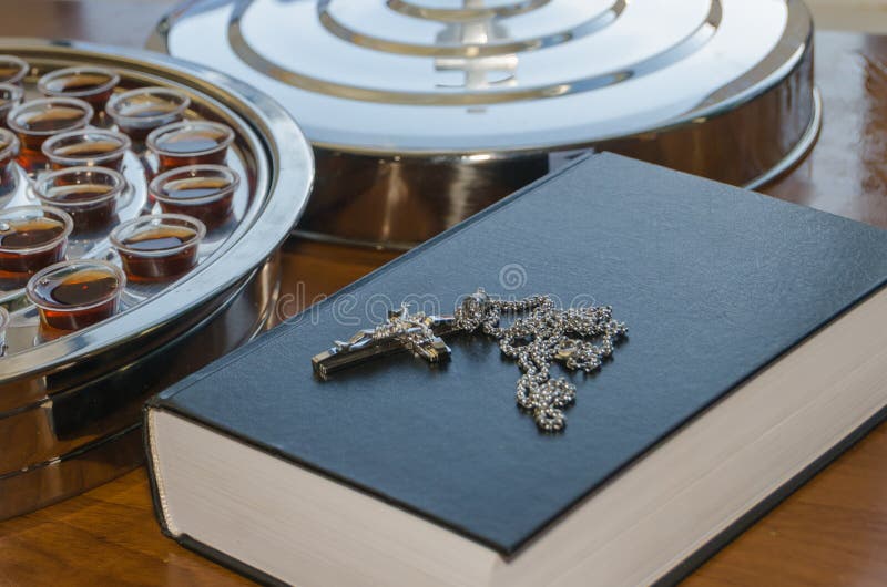 The Communion Wine and the Bible with a Crucifix on the Table Stock